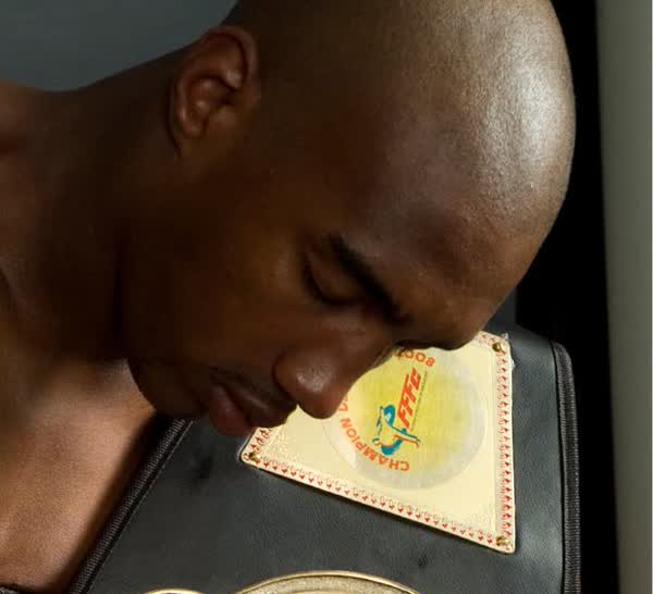 Portrait of Abdoulaye Fadiga with his FFKB French champion boxing belt